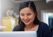 Young Asian woman looking at computer screen