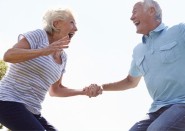 Happy older couple jumping in air